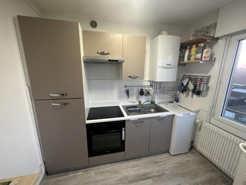 une petite cuisine avec un évier et une cuisinière dans l'établissement Appartement - 6 voyageurs - Proche de la plage, à Bray-Dunes