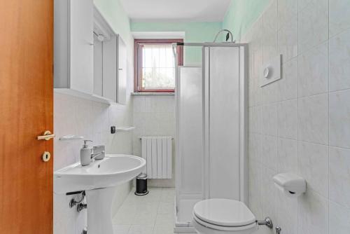 a white bathroom with a toilet and a sink at -Free Parking & Pool- Casa a pochi passi dal Lago in Padenghe sul Garda