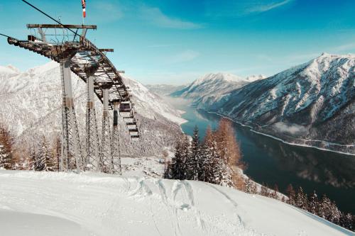 a ski lift on top of a snow covered mountain at Hotel St. Georg zum See in Maurach