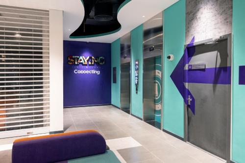 a dressing room with a purple and blue wall at Tru by Hilton Buon Ma Thuot City Centre in Buon Ma Thuot