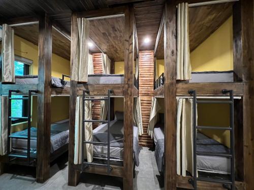 a group of four bunk beds in a room at Lapis Restaurant and Hostel in Vũ Lâm