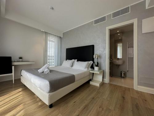 ein Schlafzimmer mit einem großen Bett und einem TV in der Unterkunft Boutique Hotel Bali in Lido di Jesolo