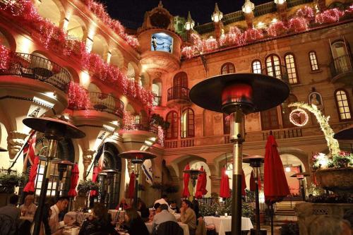 a group of people sitting at tables in a building at The Mission Inn Hotel and Spa in Riverside