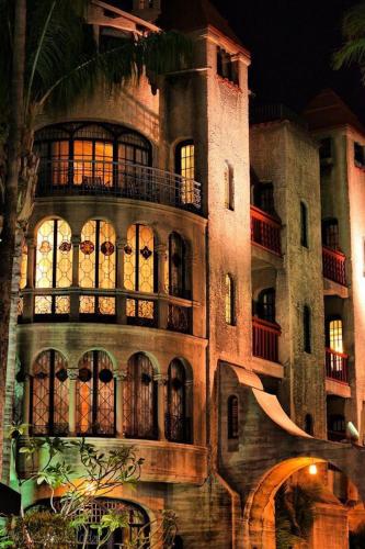 a large building with a lot of windows at night at The Mission Inn Hotel and Spa in Riverside