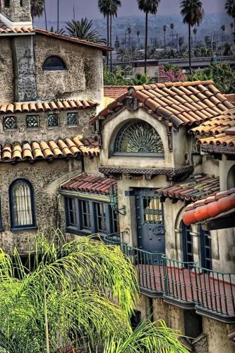 an old house with a blue door and a roof at The Mission Inn Hotel and Spa in Riverside