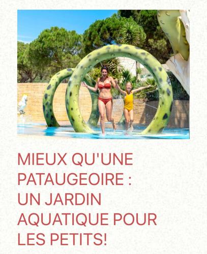 a woman and a child in the water at a water park at Camping les Cigales - Mobil-home 4/6 personnes in Le Muy
