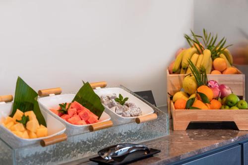 three trays of fruits and vegetables on a counter at Pagoda Hotel Shenzhen Familytrip&BusinessTravel in Shenzhen
