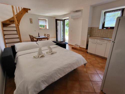 a bedroom with a large white bed with two bows at Holiday Home Belka with Terrace&BBQ in Tolmin