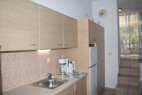 a kitchen with a sink and a coffee maker at Seaside Nicola's Studio in Matala