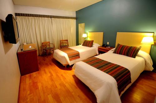 Säng eller sängar i ett rum på Hotel Argos