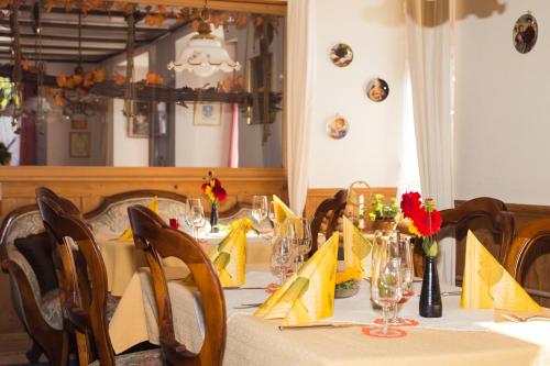 a dining room table with yellow napkins and yellow napkinsktop at Gasthaus zum Bären in Bözen