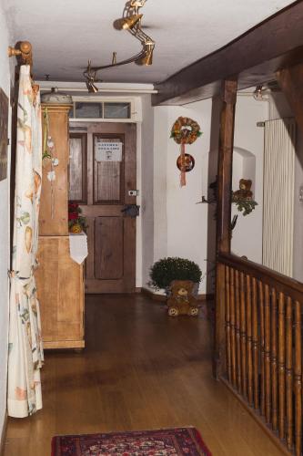 a hallway of a house with a door and a rug at Gasthaus zum Bären in Bözen