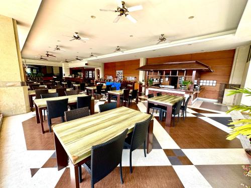 a dining room with tables and chairs and a restaurant at Sea Passion Hotel in Koror