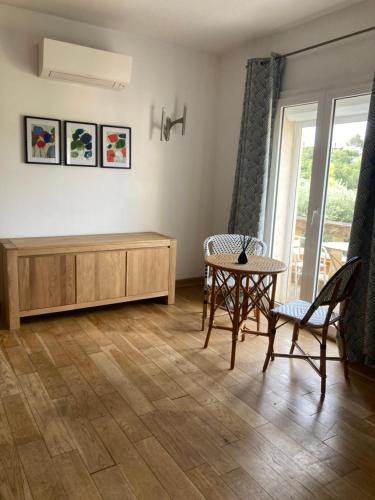 a living room with a couch and a table at Castel'lodge in Le Beausset