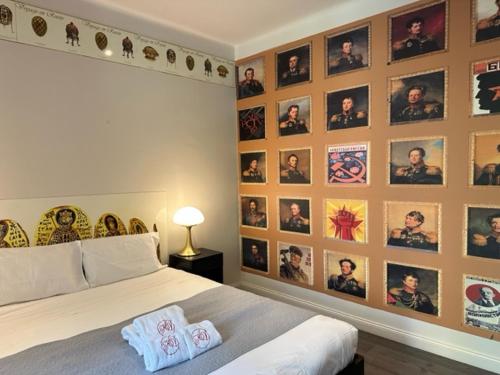 a bedroom with a wall with pictures on it at Hôtel Les Voyageurs in Bastia