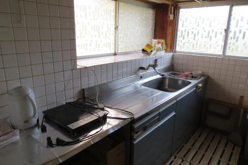 a kitchen with a sink and a counter top at Guest house Matsuo 