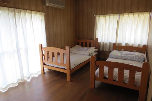 a bedroom with two bunk beds and a window at Guest house Matsuo 