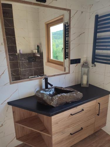 a bathroom with a sink and a mirror at Domek u Sołtyska in Rajcza