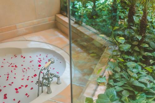 a bathroom with a bath tub with red hearts on it at Le Meridien Jaipur Resort & Spa in Jaipur