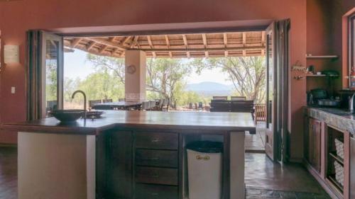 a kitchen with a counter and a large window at 203 Zebula - 5 Bedroom 20 sleeper in Mabula