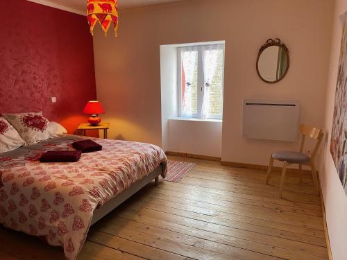 a bedroom with a bed and a window and a mirror at CHAMBRE D HOTES CHEZ DANY MAOWMAOW ET GARFIELD in Bellevue-la-Montagne