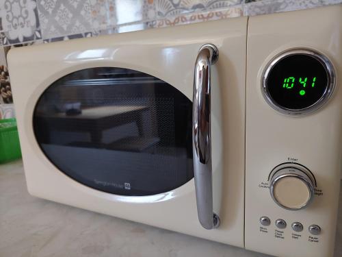 a toaster oven with a clock on it at DOBRA GAZDA - transit sleep in Dobra