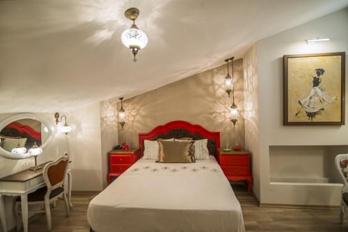 a bedroom with a bed and a desk and a tub at La Vie Konak Otel in Eskisehir