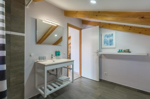 a bathroom with a sink and a mirror at Apartments Agata in Novigrad Istria