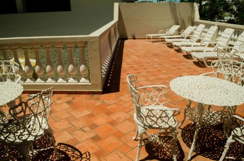 a row of tables and chairs on a patio at Pousada Portal do Mar in Cabo Frio