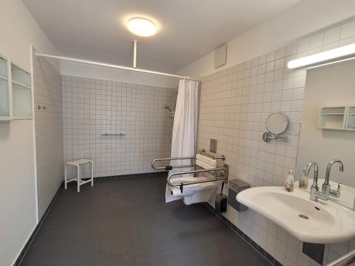 a bathroom with a sink and a tub and a toilet at Hotel Brandenburger Dom in Brandenburg an der Havel