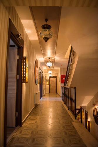 a hallway of a building with a staircase and a chandelier at La Vie Konak Otel in Eskisehir