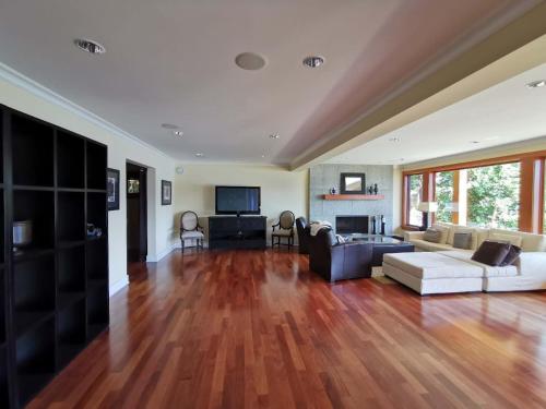 a living room with a couch and a table at Deep Cove Stunning Waterfront Whole House in North Vancouver