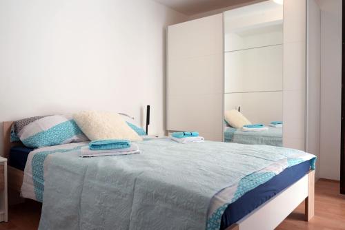 a bedroom with a large bed with a mirror at Toma Apartman in Bilice