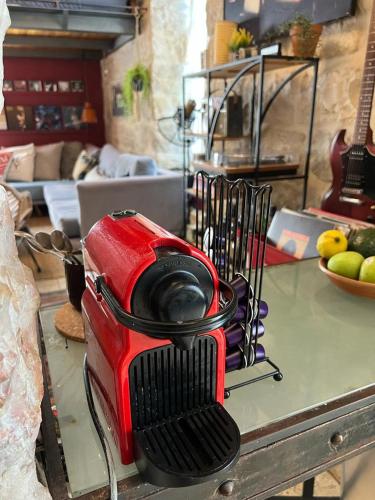 a red blender sitting on top of a table at נרקיס NARKIS in Jerusalem
