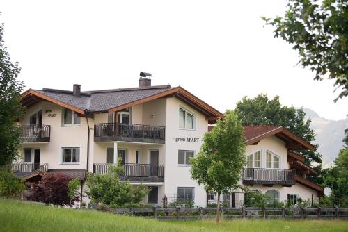 a large white building with balconies and trees at Green Apart in Uderns