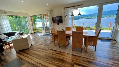 - un salon avec une table, des chaises et un canapé dans l'établissement Lipno Villa Beach - Lipno Stausee - Lakeside, à Loučovice