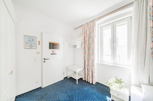 a bathroom with a toilet and a window at Self-Check-In Hotel Adlon in Vienna