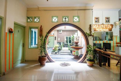 an archway in a room with potted plants at RedDoorz near Kartini Mall Lampung in Bandar Lampung