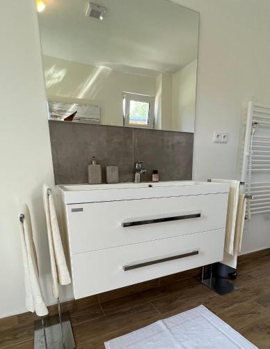 a bathroom with a white sink and a mirror at Lipno Villa Beach - Lipno Stausee - Lakeside in Loučovice