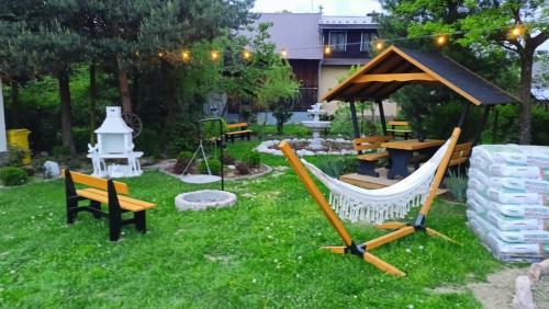 a backyard with a hammock and a gazebo at Domek z Góralską Duszą Śleboda in Jurgów
