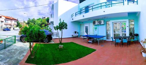 a house with a ping pong table in the yard at Grace : Garden and Terrace House in Kavala