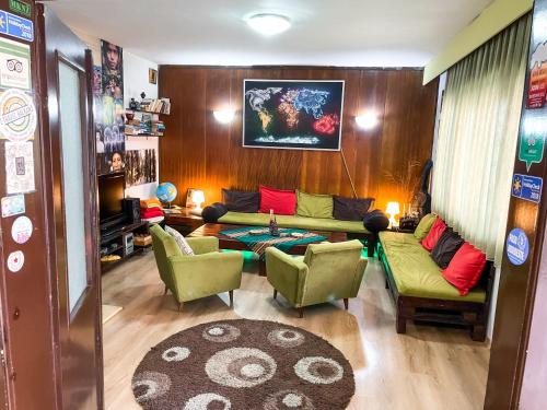 a living room with a couch and two chairs at Hi Skopje Hostel in Skopje