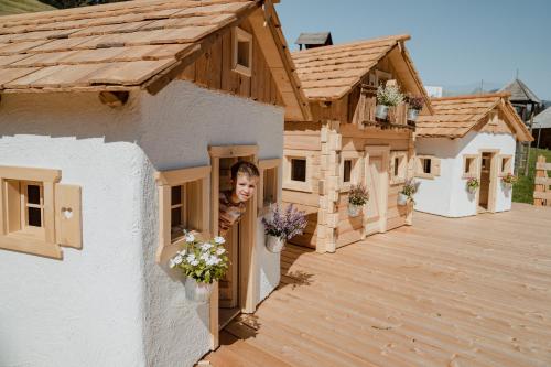 a woman looking out of a window of a house at Natur- und Wellnesshotel Höflehner in Haus im Ennstal