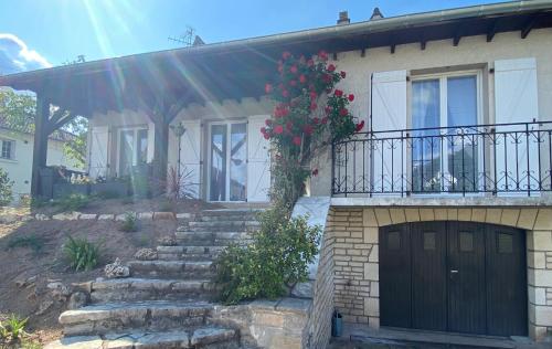 a house with a black door and a balcony at Gite-le-7 in Brive-la-Gaillarde