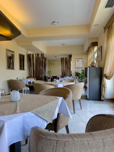 a restaurant with tables and chairs in a room at Hotel Theresia in Kolín