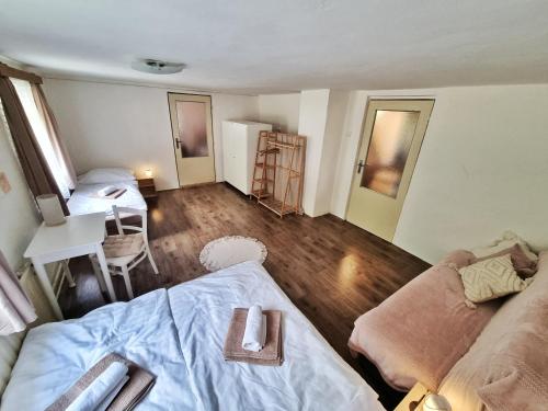 a room with a couch and a bed and a desk at Domek č. 3 in Pürstein
