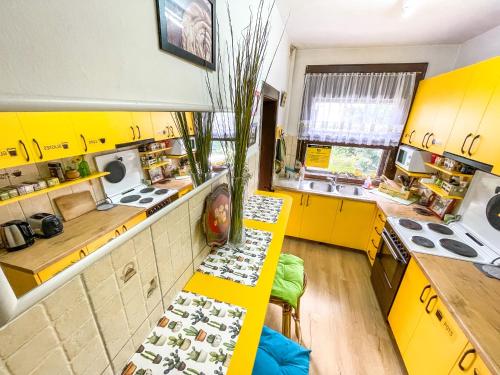a kitchen with yellow cabinets and a yellow counter at Hi Skopje Hostel in Skopje