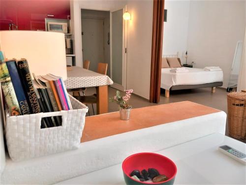 a living room with a table with books on it at ApartEasy - Private terrace, TURO PARK in Barcelona
