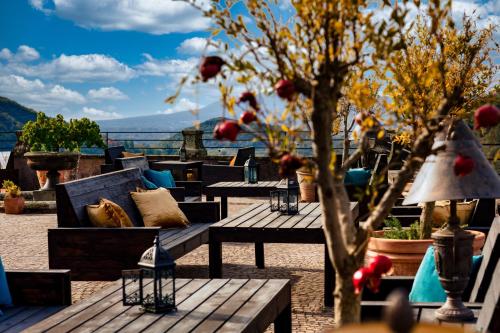 a row of benches and tables on a roof with trees at Castello Brancaccio in San Gregorio da Sassola