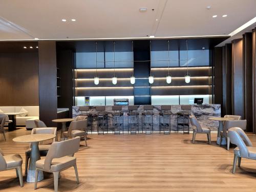 a lobby with tables and chairs and a bar at VM Hotel in Phnom Penh
